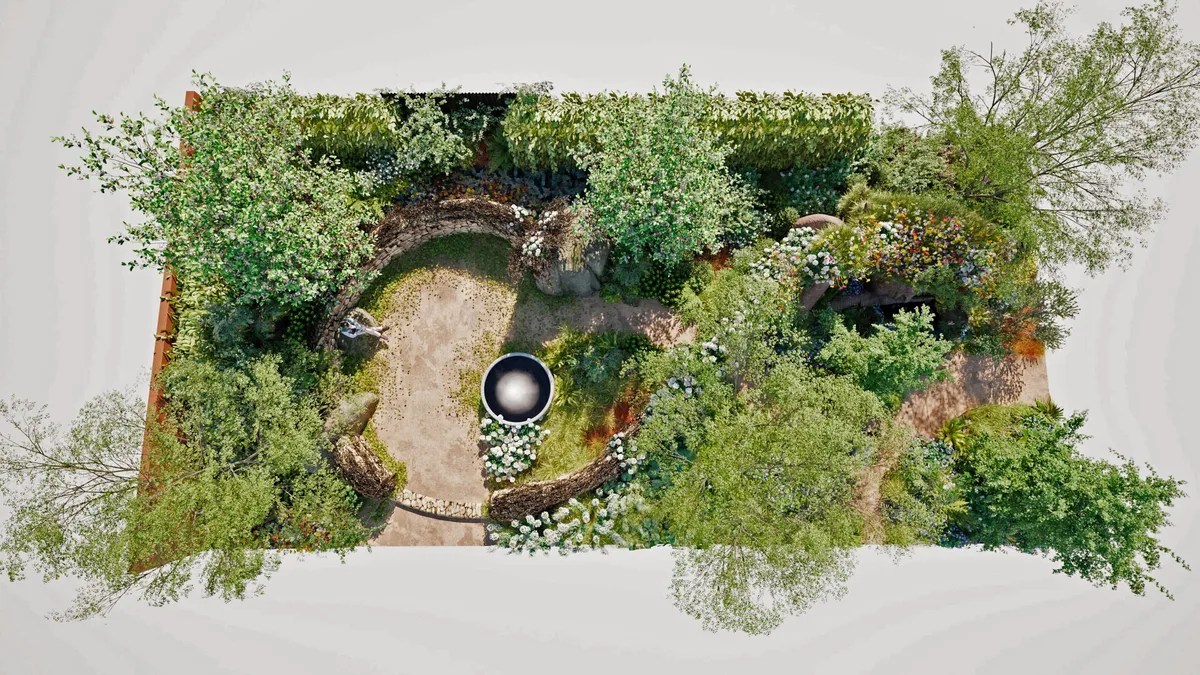 Aerial view of the Campaign to Protect Rural England – On the Edge show garden designed by Sarah Eberle for the RHS Chelsea Flower Show. The design features a circular, sunken seating area bordered by curved dry-stone walls, a reflective black water bowl at its centre, and densely planted perimeters of trees, shrubs, and wildflowers in green and white tones. The layout creates a naturalistic, enclosed sanctuary with winding paths and layered planting that evoke the edge of a woodland or coastal landscape.