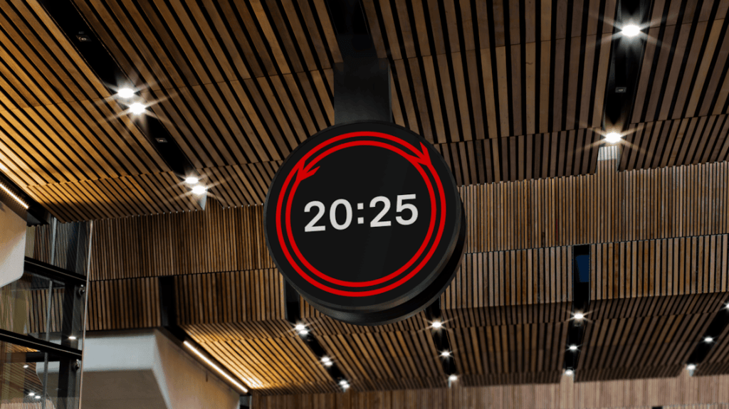 A circular black digital clock hanging from a wooden slatted ceiling with recessed spotlights, displaying the white text "20:25" inside a red-parallel track style bordered circle with bidirectional arrows indicating the seconds on a loop or cycle.